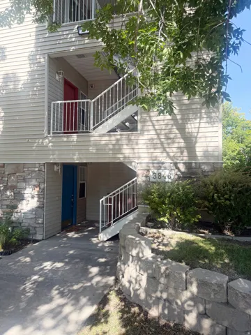 Multi-level building with stone veneer base and horizontal siding