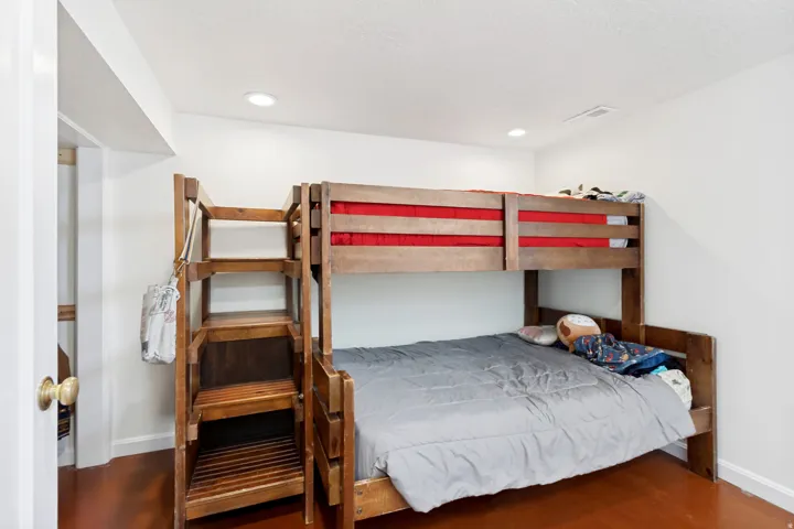 Room featuring recessed lighting, white walls, and a built-in wooden bunk bed