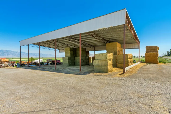 Large open-air structure featuring a metal roof and steel support beams