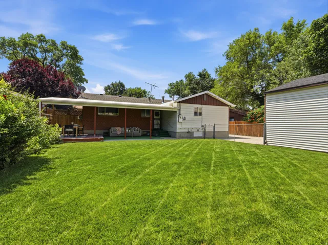 Expansive green lawn with mature perimeter trees