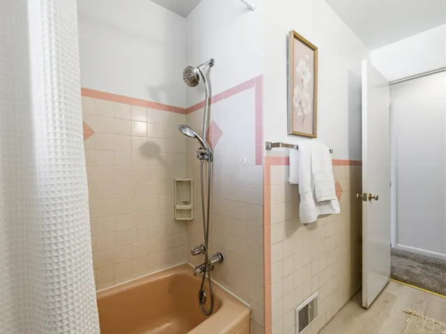 Bathroom featuring a tub and shower combination with a handheld showerhead