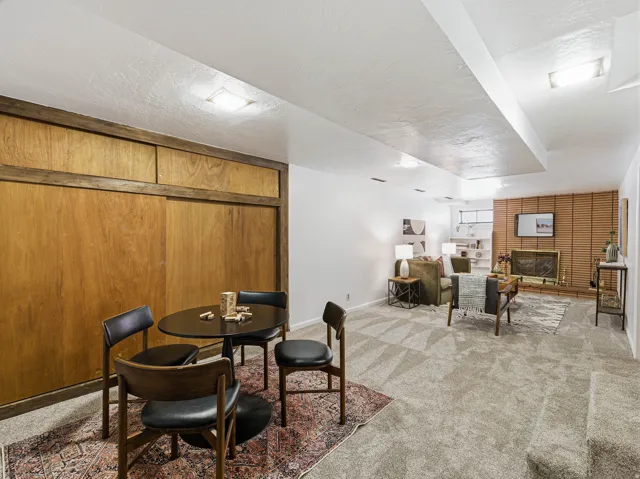 Spacious lower-level area with wood paneling and recessed lighting