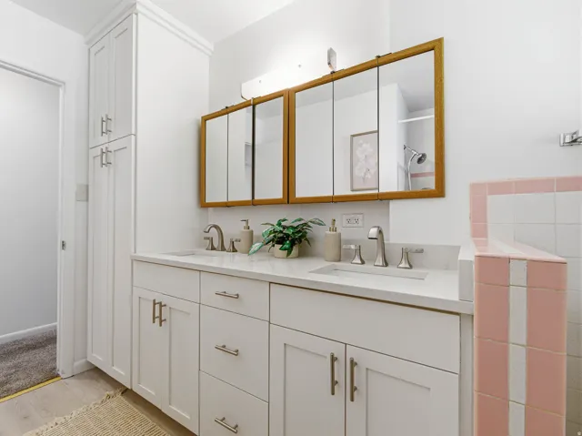 Double vanity with white cabinetry and integrated sinks
