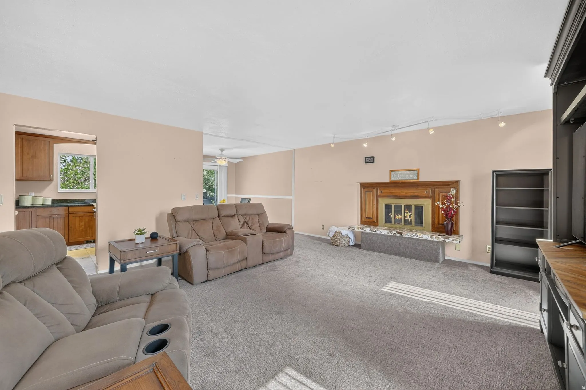 Spacious living area featuring neutral carpeting and light-toned walls