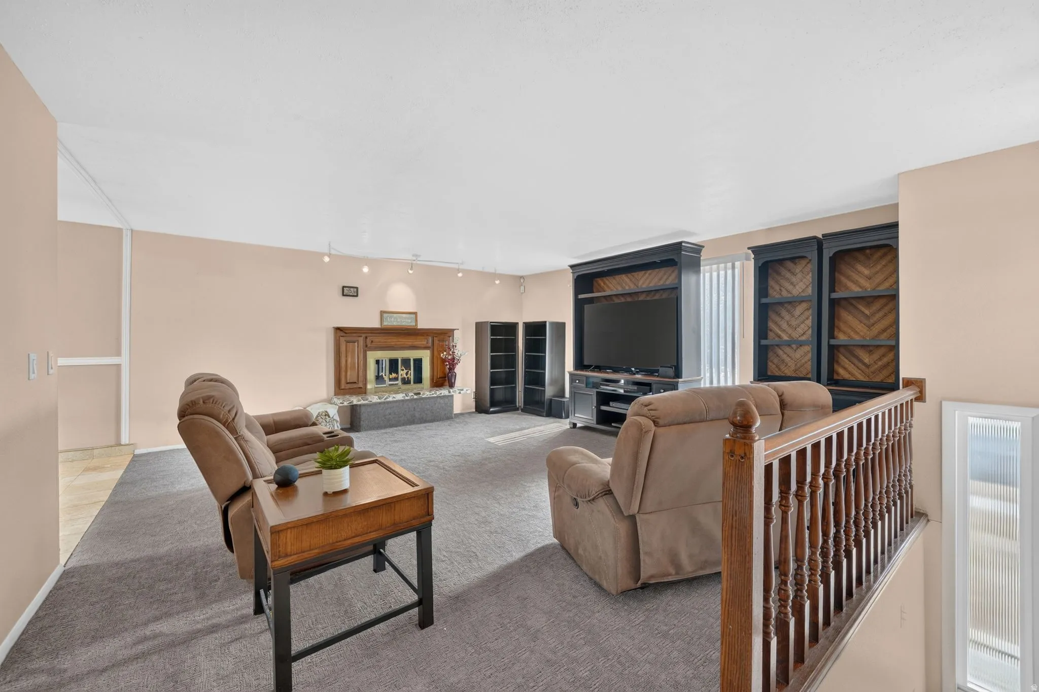 Spacious living area featuring neutral carpeting and light-toned walls