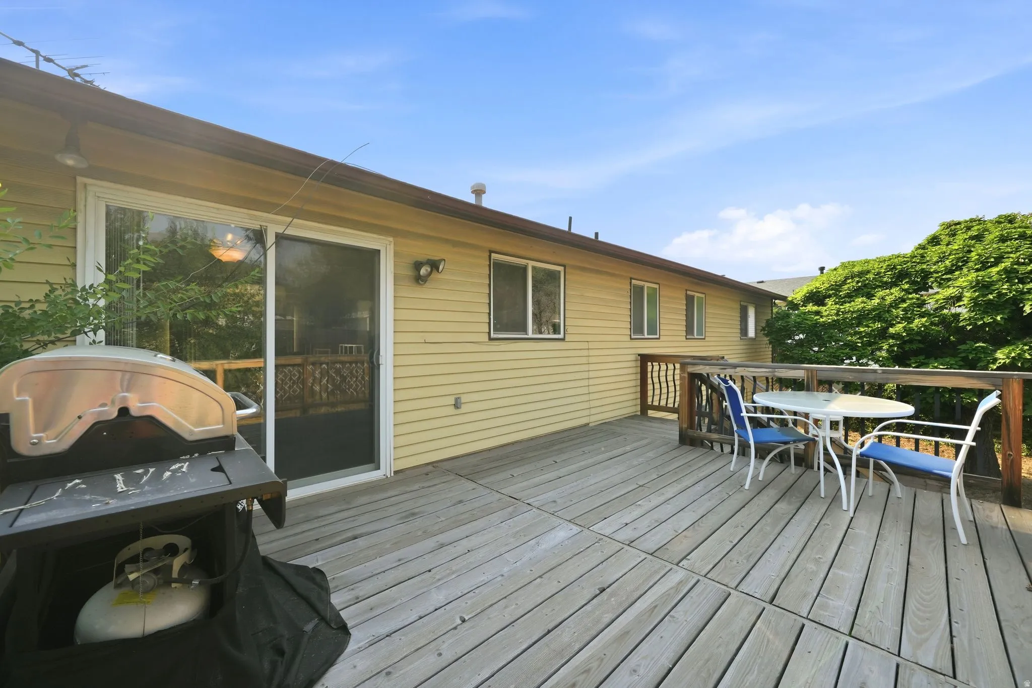 Spacious wood deck with a sliding glass door entry