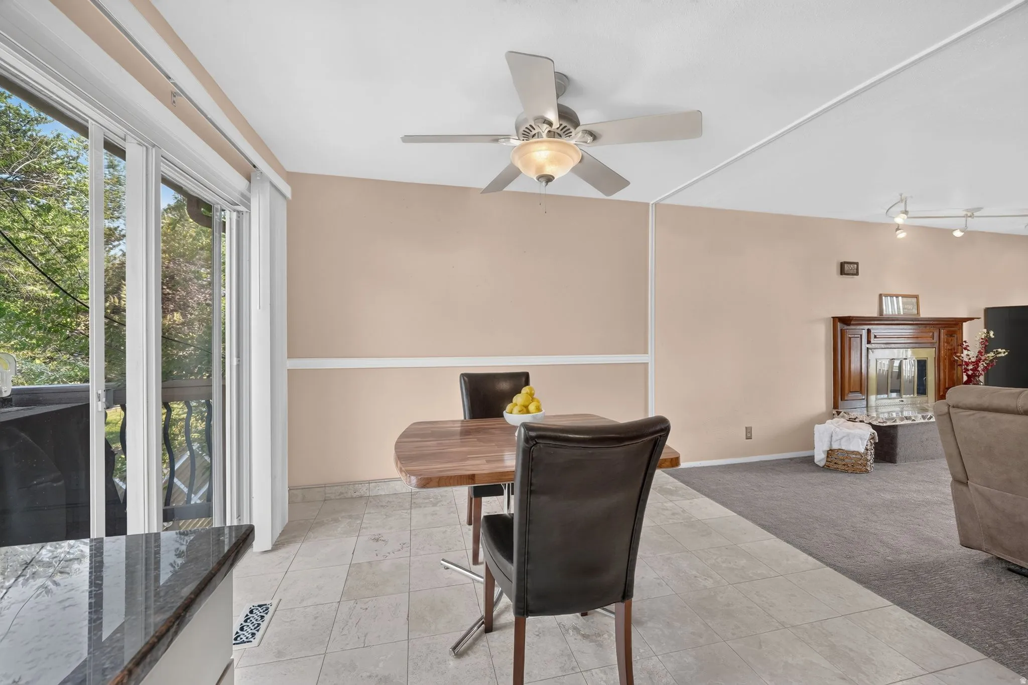 Expansive living area with a vaulted ceiling, ceiling fan, and recessed lighting