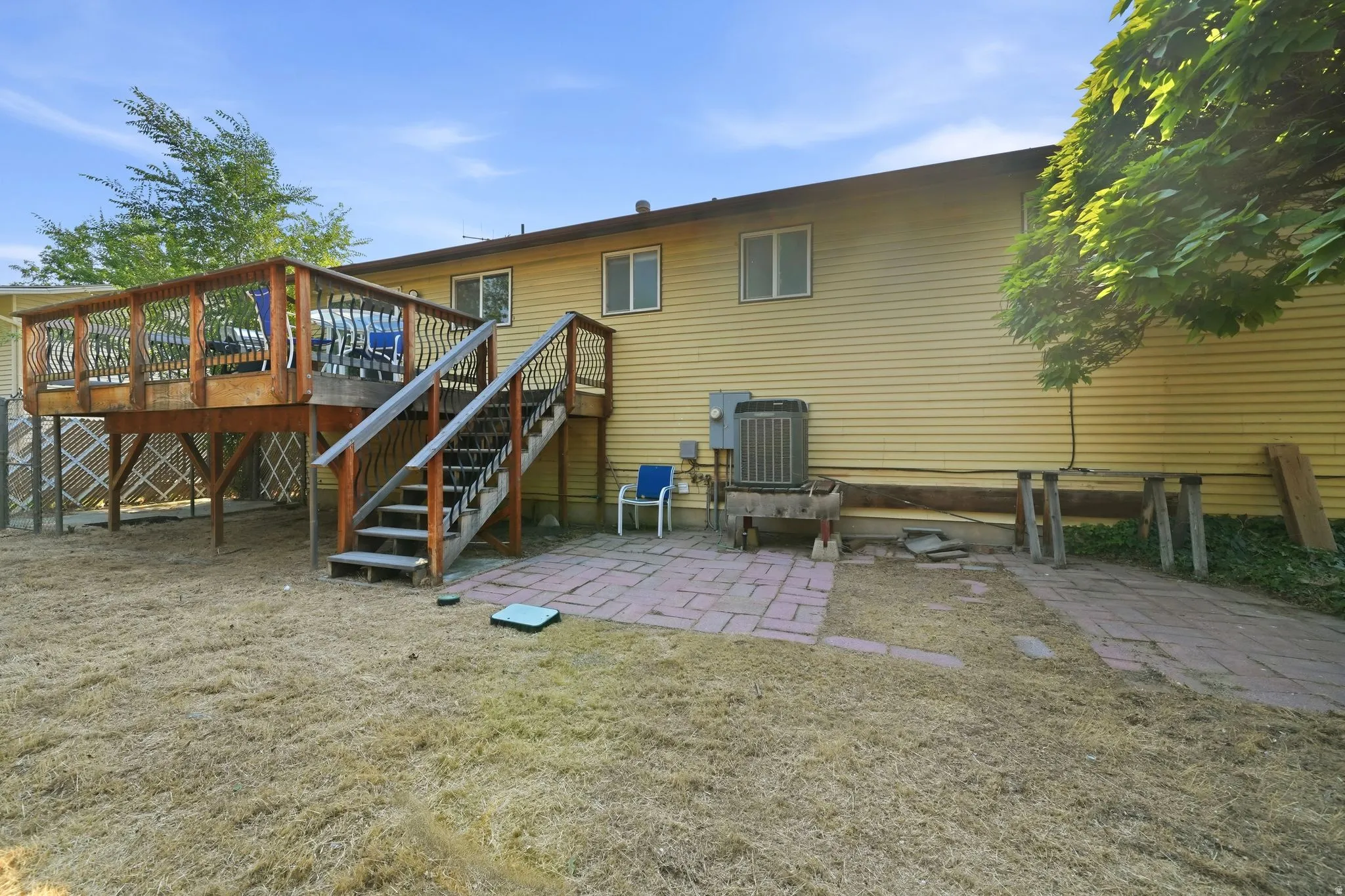 Elevated wood deck with baluster railing and staircase