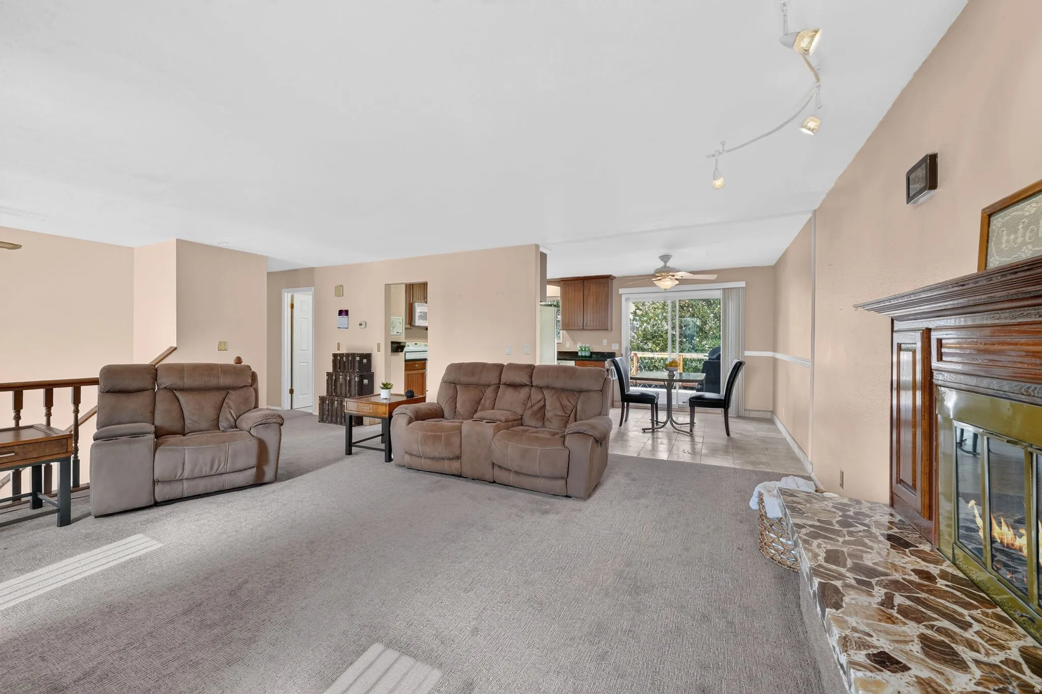 Living area featuring a fireplace with a stone hearth and wood mantel