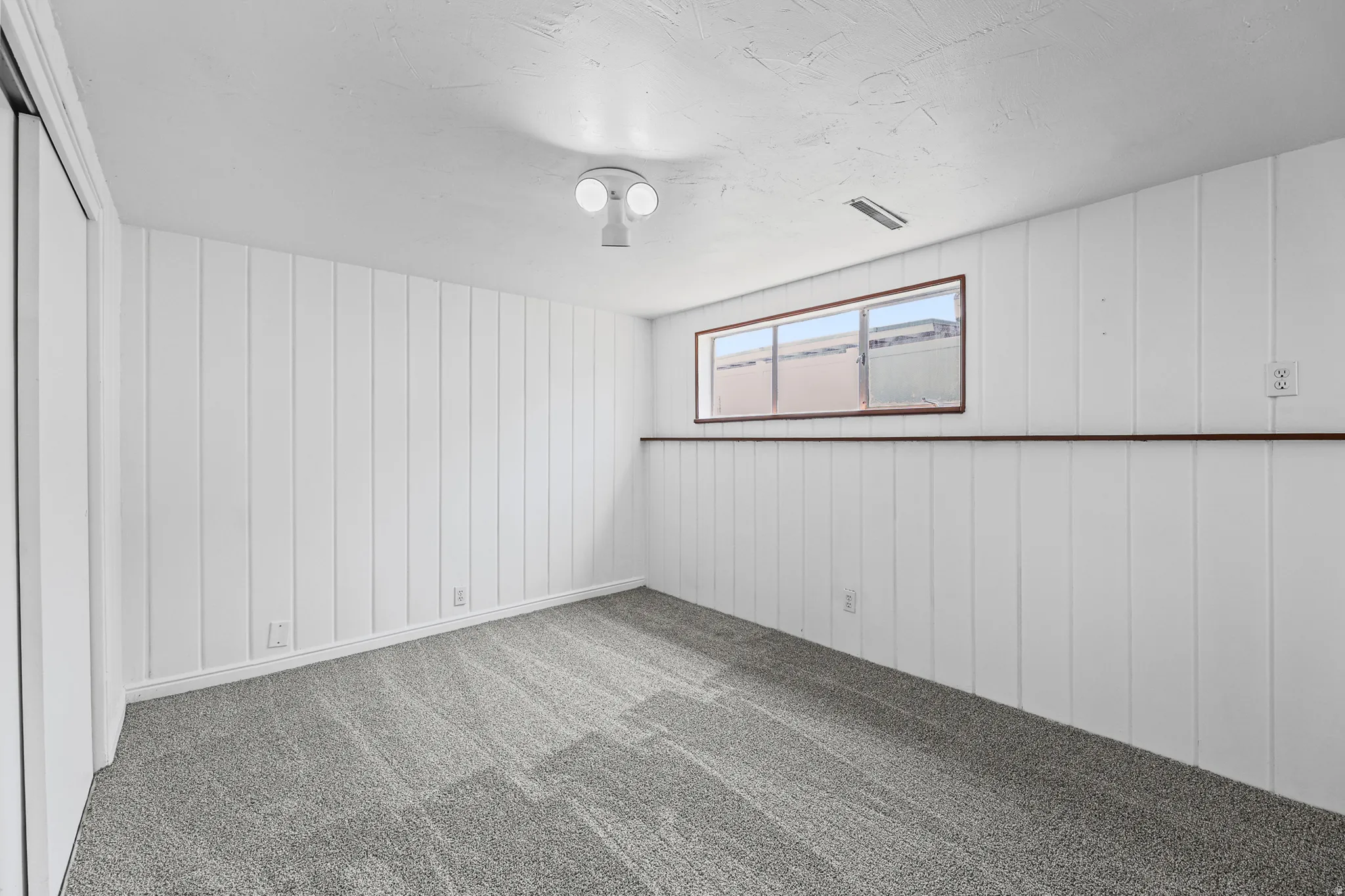 Newly painted basement large rec room.