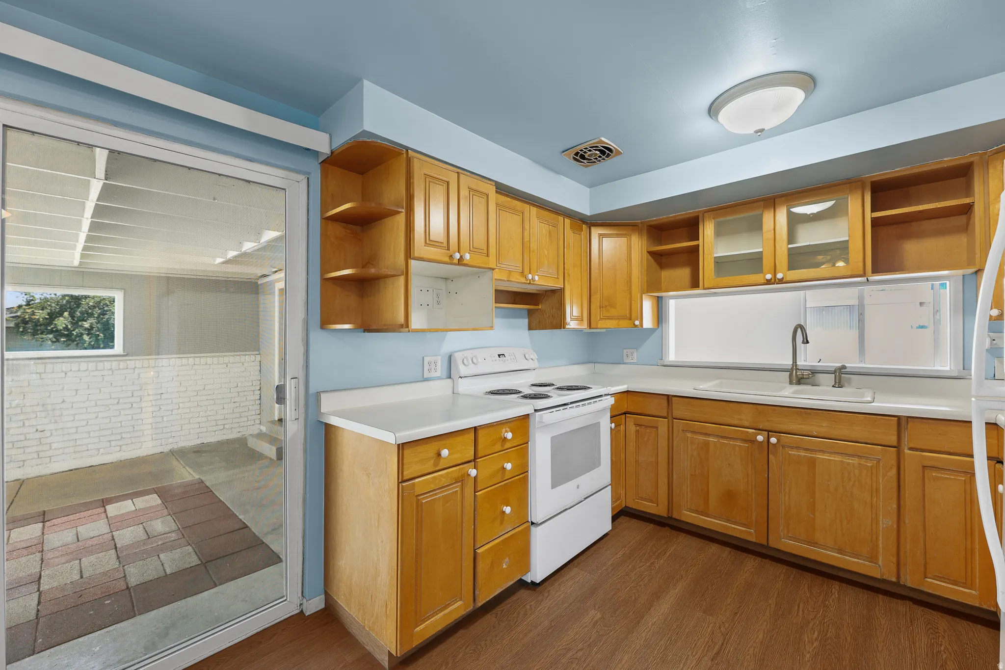 Kitchen featuring sliding glass door leading to a covered patio.