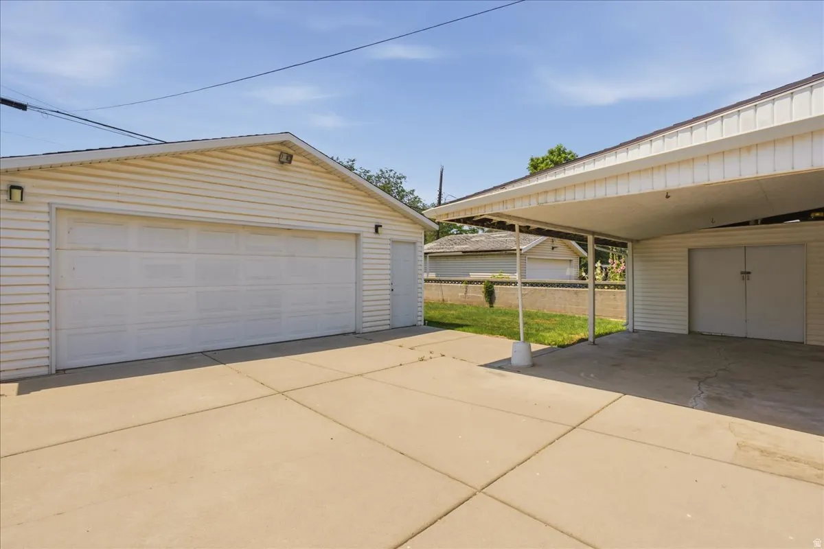 Detached two-car garage with white paneled door and side entry