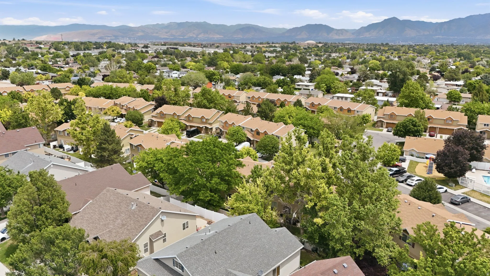 Aerial perspective showcasing a residential neighborhood with varied architectural styles and mature trees