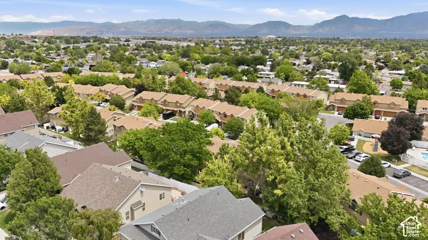Aerial perspective showcasing a residential neighborhood with varied architectural styles and mature trees