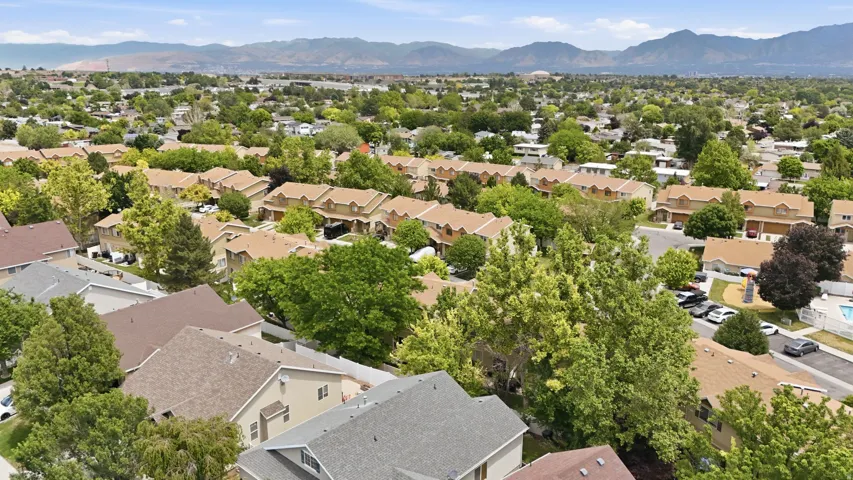 Aerial perspective showcasing a residential neighborhood with varied architectural styles and mature trees
