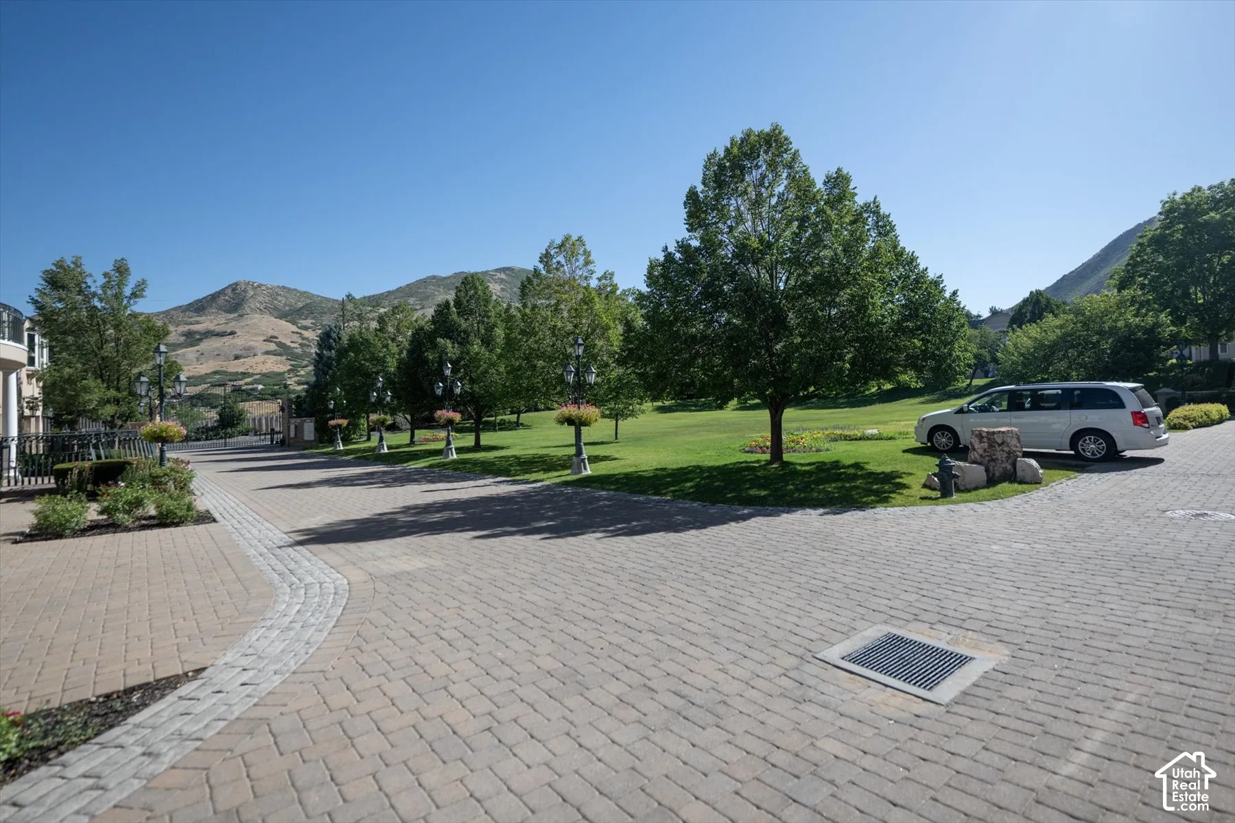 Brick paver driveway with a curved stone accent strip