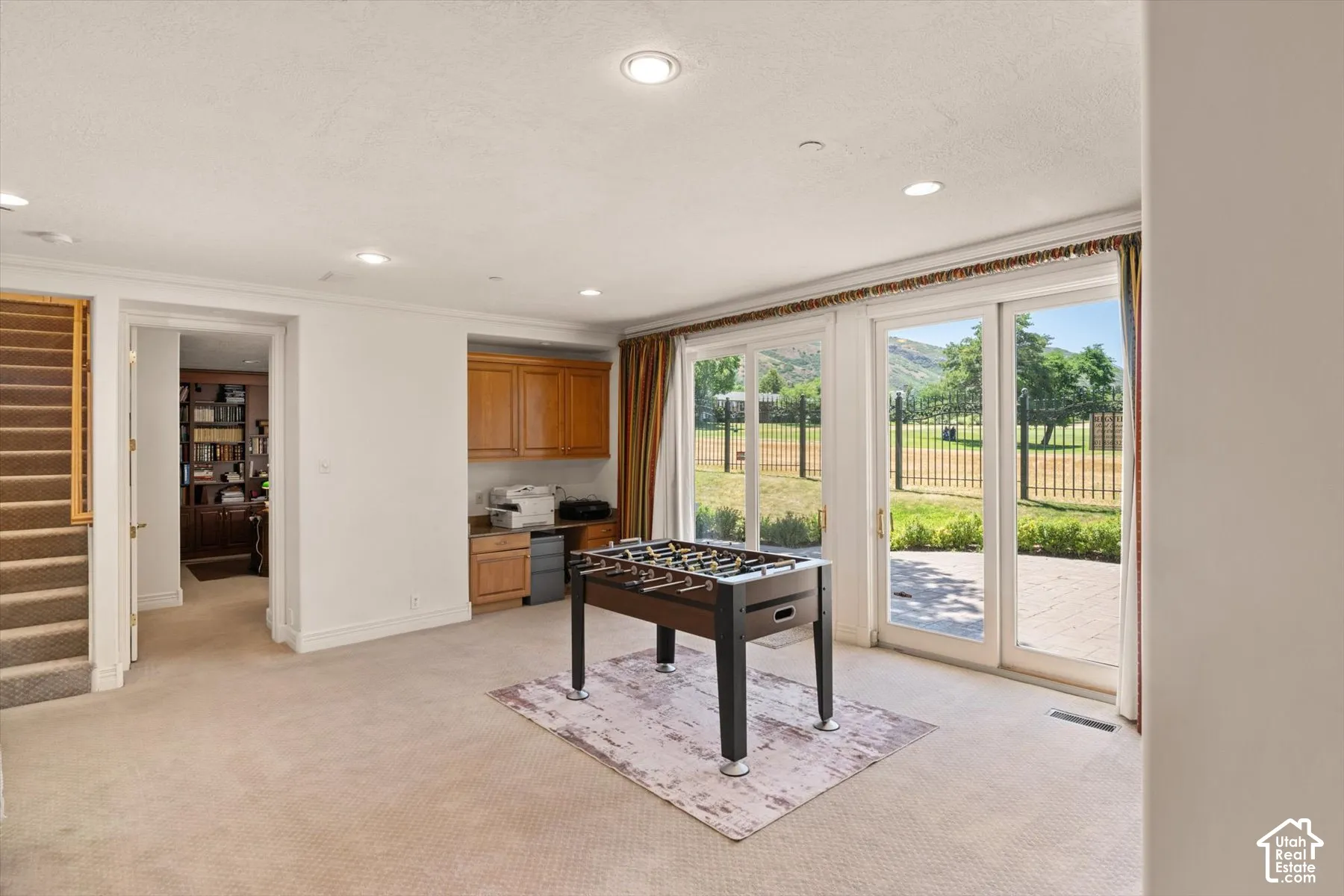 Carpeted room with recessed lighting and built-in cabinetry, walk out basement with lovely patio looking out on Bonneville Golf Course