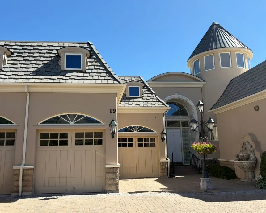 Stucco exterior featuring a prominent turret with a conical roof and multiple windows