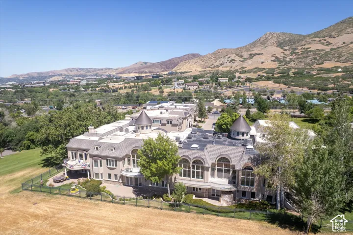 Expansive property featuring multiple structures with distinctive turret roofs and arched window designs