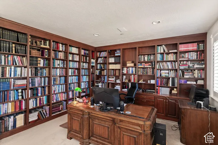 Extensive built-in wood cabinetry lines the walls, offering comprehensive storage and display capabilities, could also be bedroom