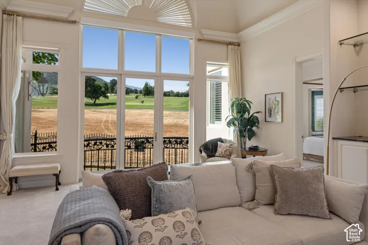Spacious interior with vaulted ceilings and expansive windows looking out at 13th green at Bonneville Golf Course!