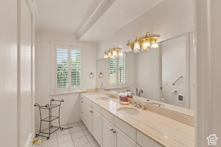 Expansive vanity with dual undermount sinks, a stone countertop and a shower