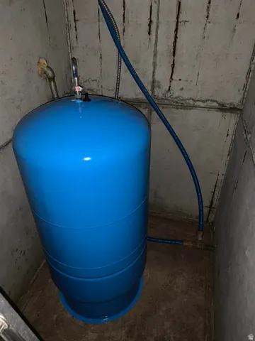 Blue pressure tank with integrated plumbing connections