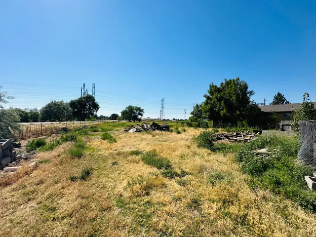 Expansive land parcel featuring natural grasses and mature trees