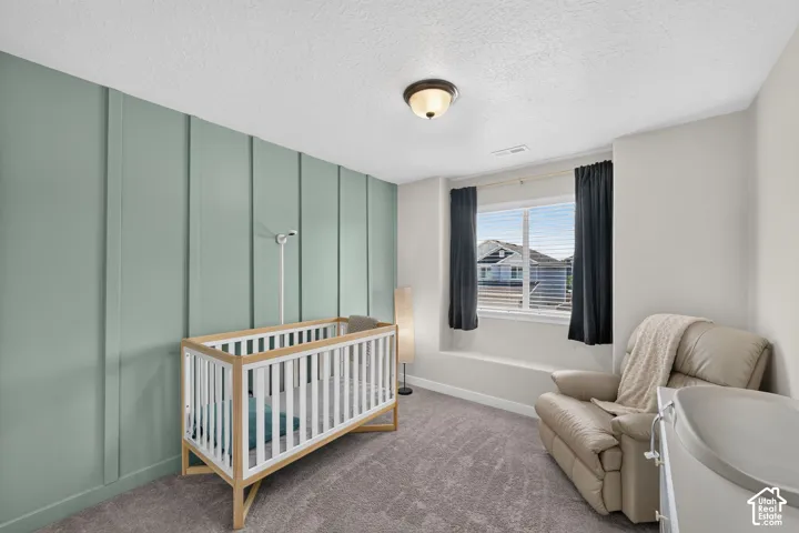 Room featuring a prominent accent wall with vertical paneling