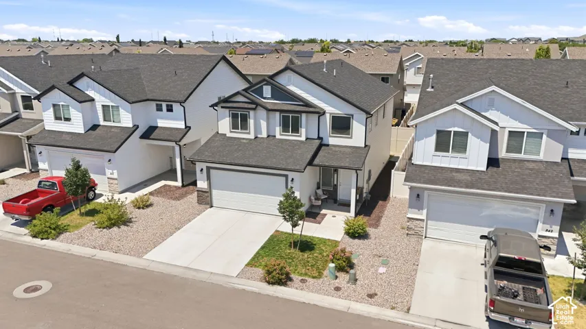 Modern two-story exterior featuring white siding and dark trim accents
