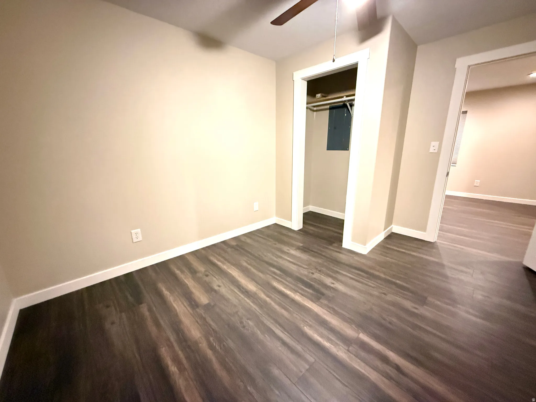 Neutral-toned interior featuring wood-finish flooring and white trim