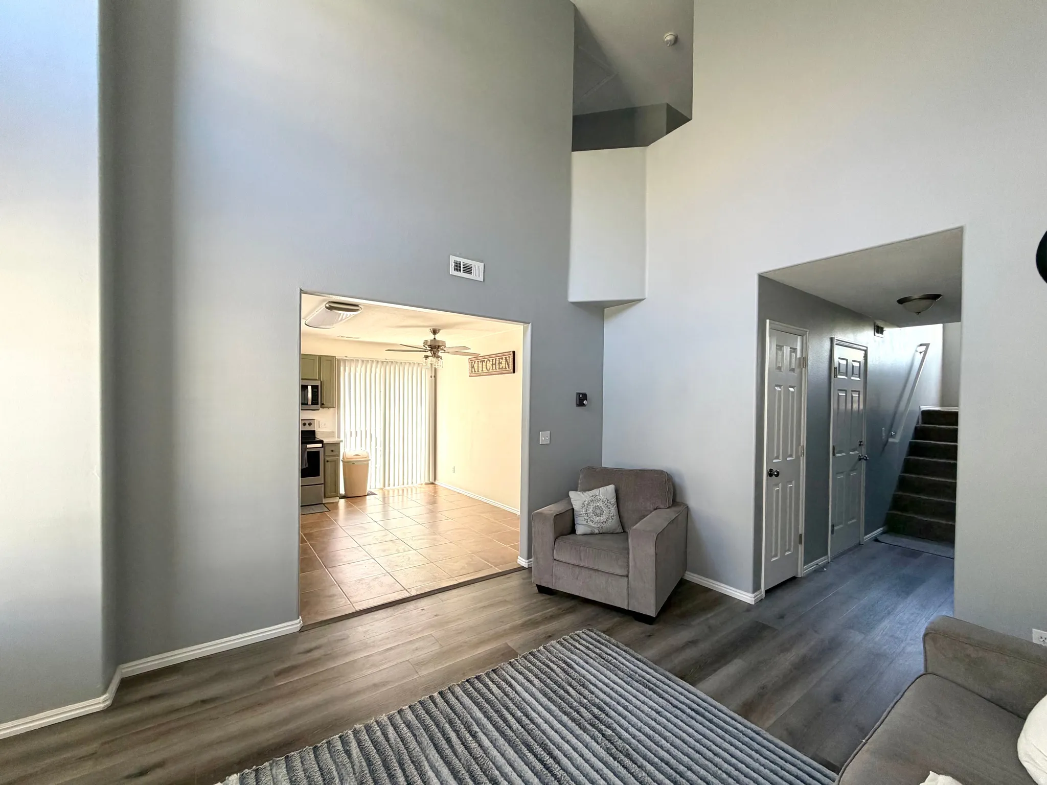 Vaulted ceilings enhance the main living area featuring wood-finish flooring