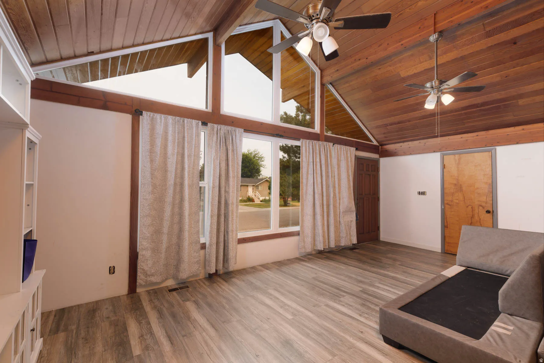 Vaulted wood-paneled ceiling with exposed beams