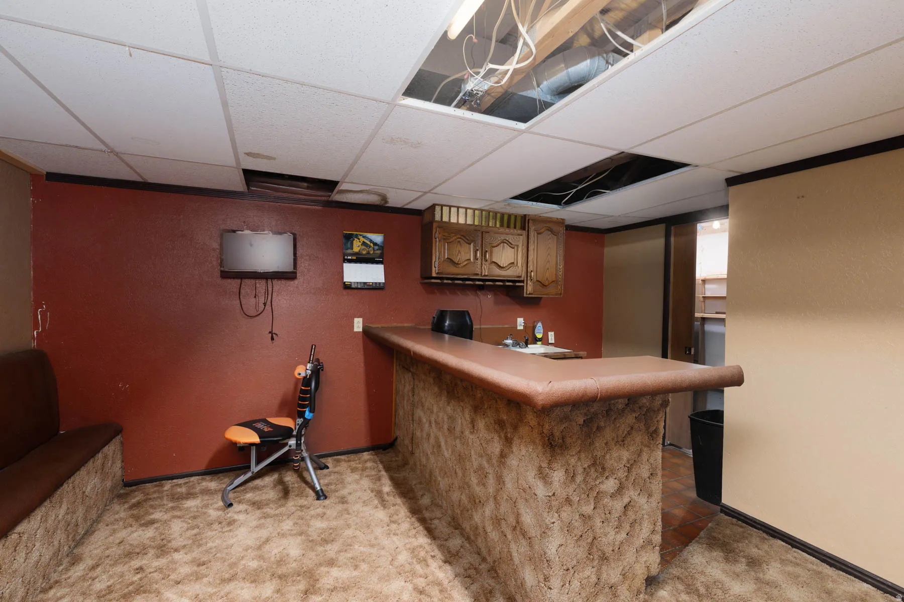 Built-in bar with a textured facade and an integrated sink