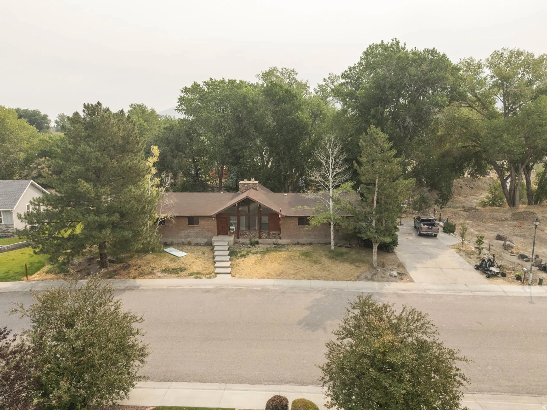 Ranch-style residence featuring a brick facade and a prominent A-frame window design