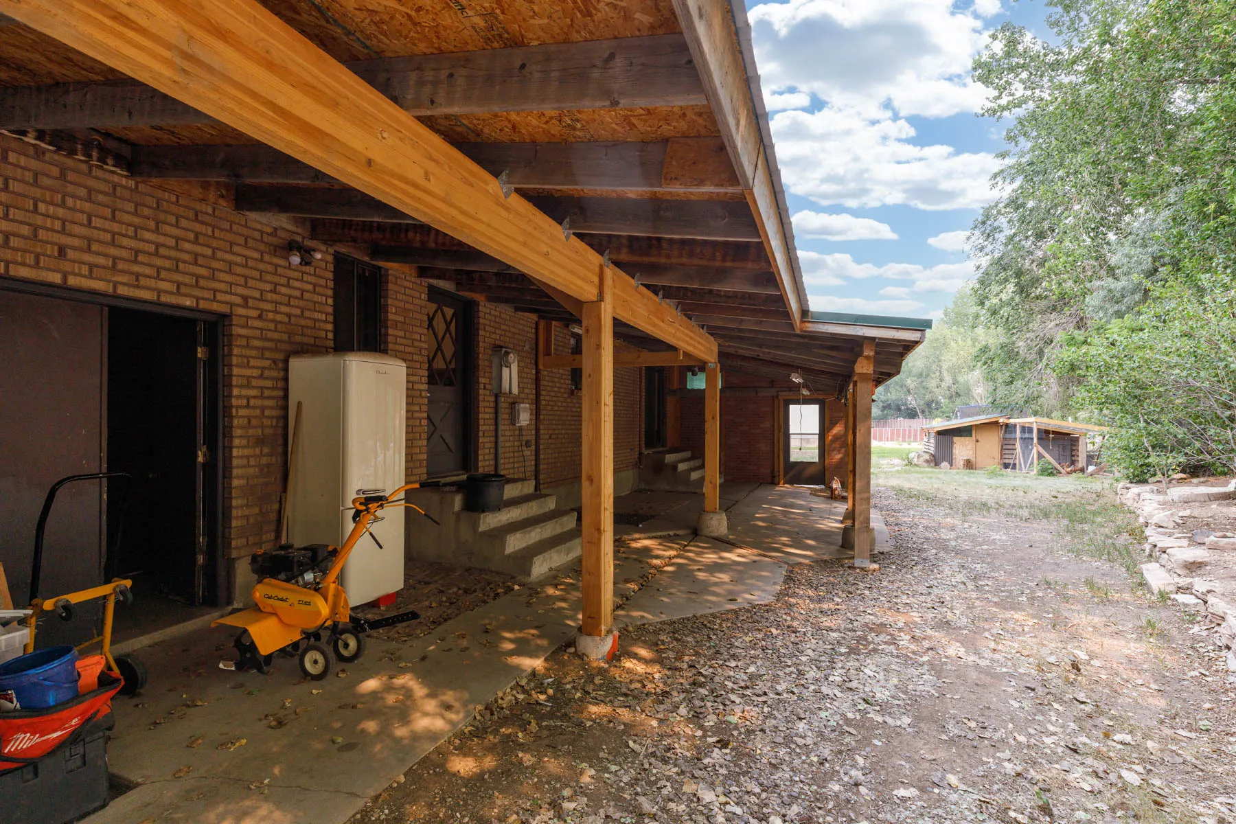 Brick exterior featuring a covered concrete patio