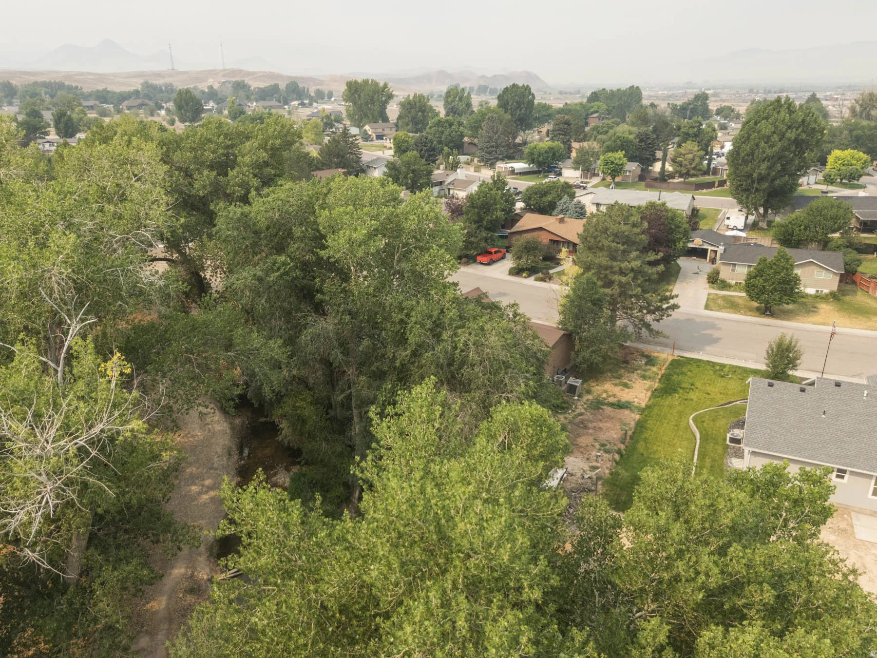 Mature trees create a lush, shaded environment surrounding the property