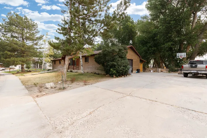 Expansive concrete driveway with a basketball hoop