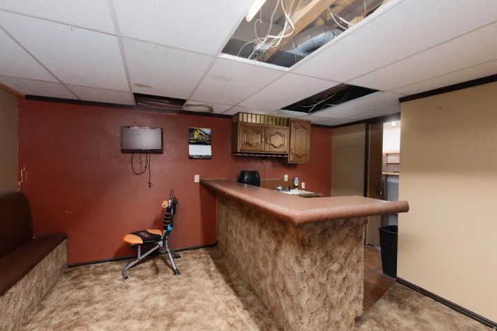 Built-in bar with a textured facade and an integrated sink