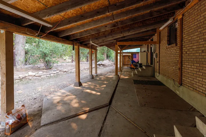 Covered patio featuring a concrete surface and exposed wood beam ceiling
