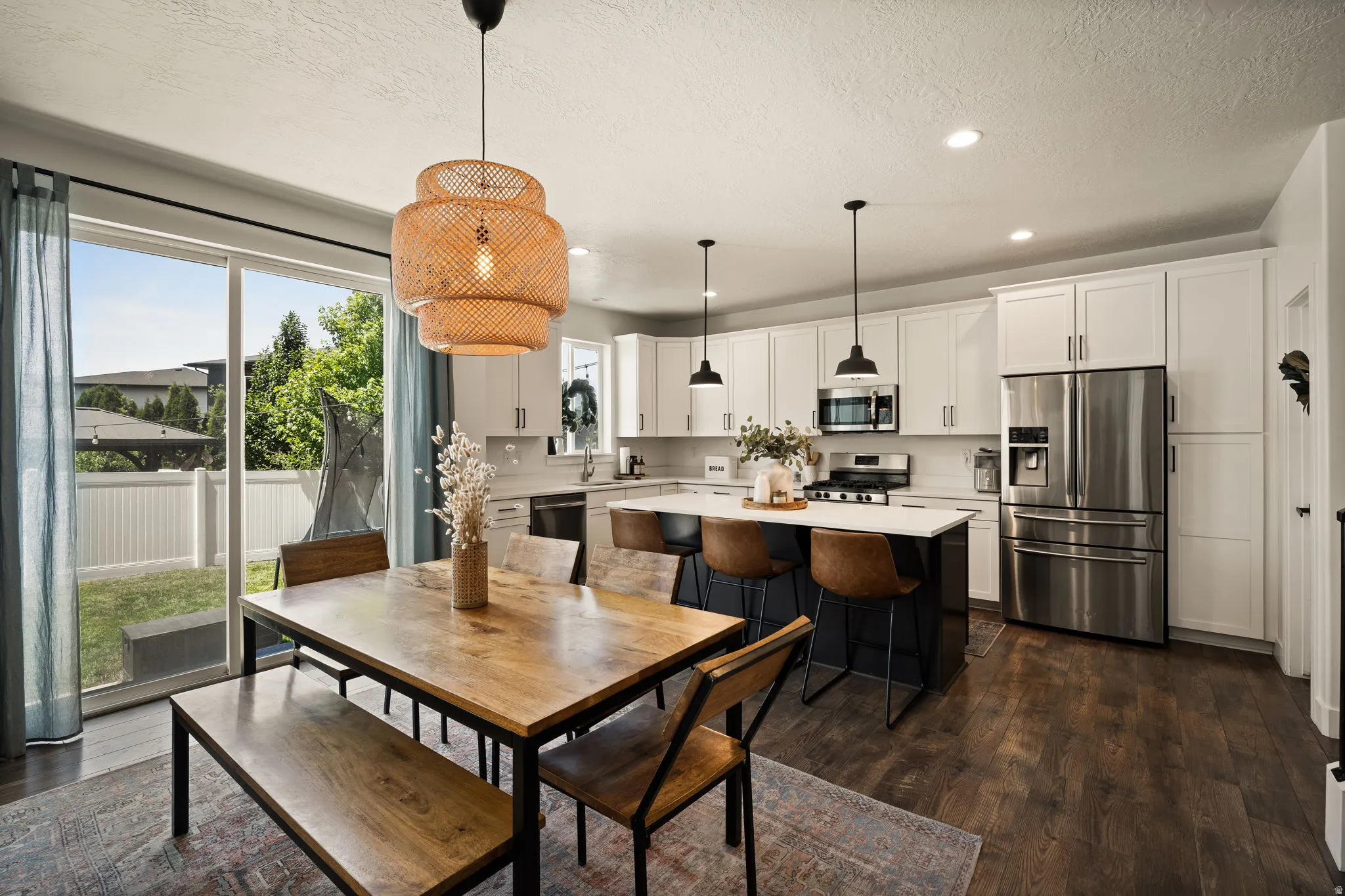 Open-concept kitchen and dining area featuring a sliding glass door to the backyard