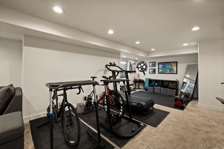 Spacious lower-level room featuring recessed lighting, a neutral color palette, and soft carpet flooring