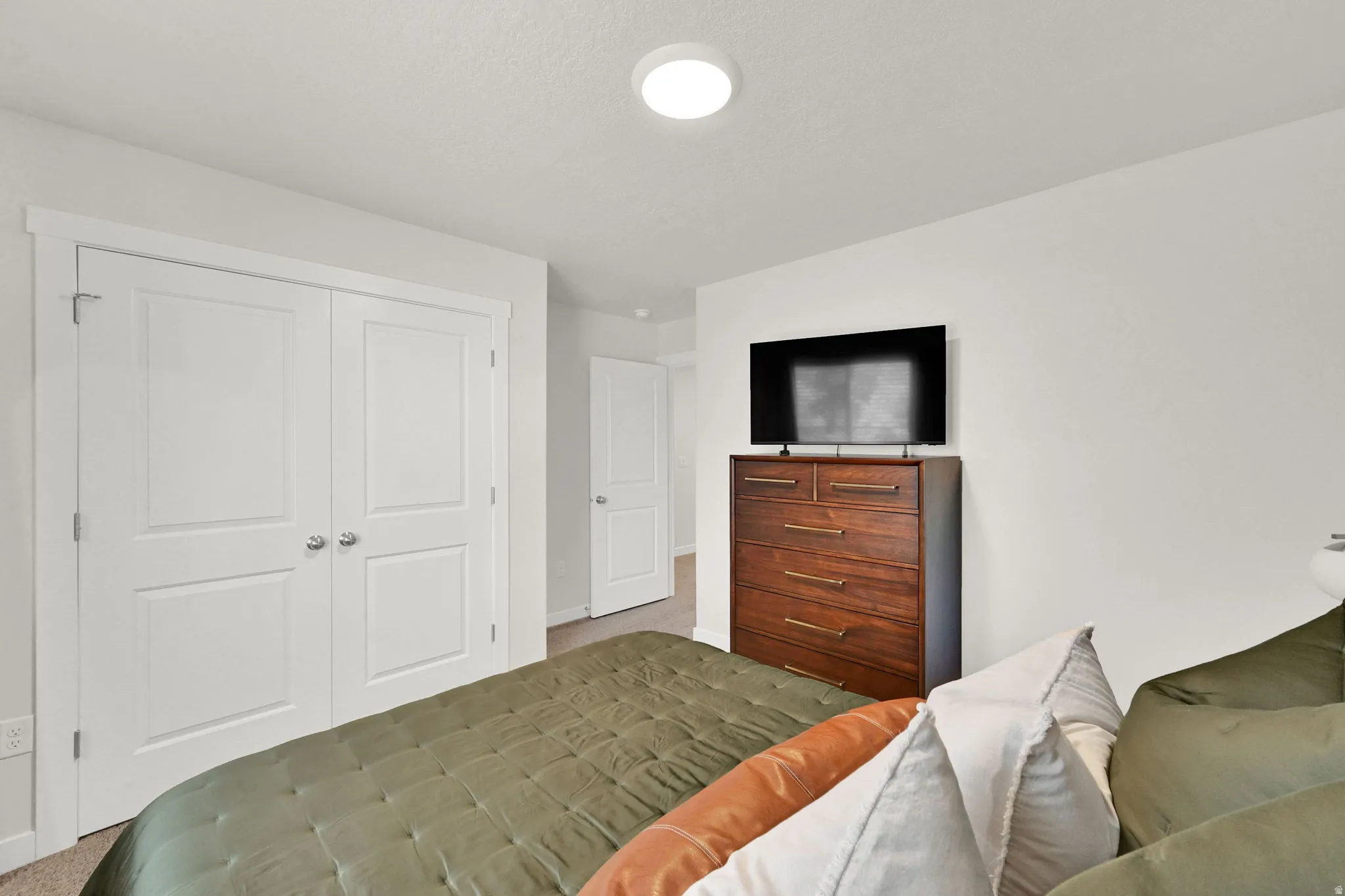 White paneled bi-fold closet doors with chrome hardware