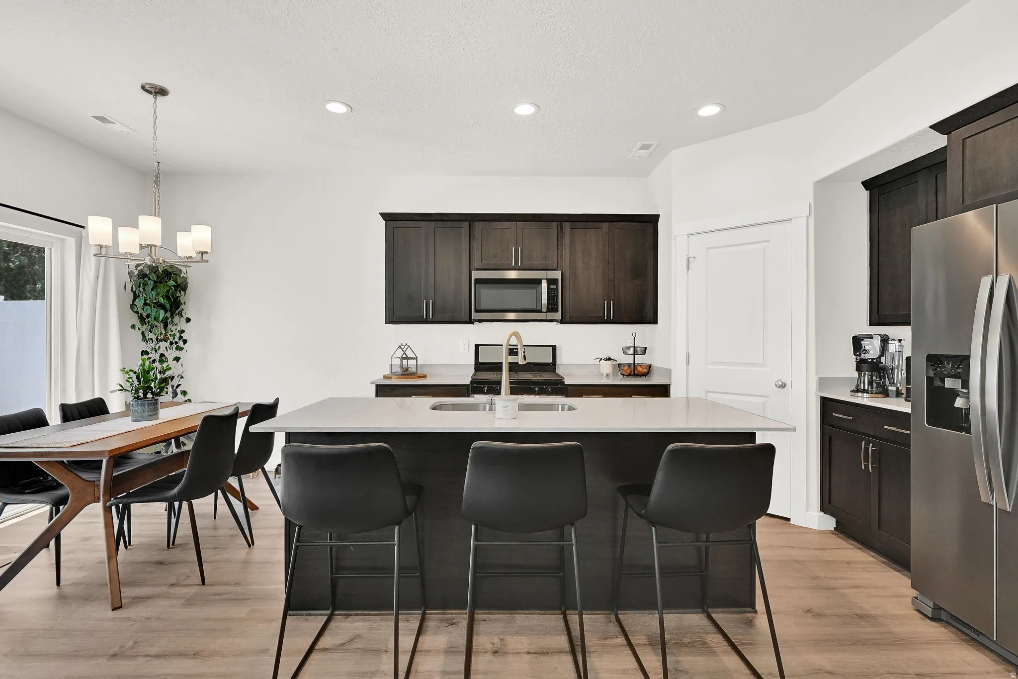 Contemporary kitchen with a central island featuring a light-toned countertop