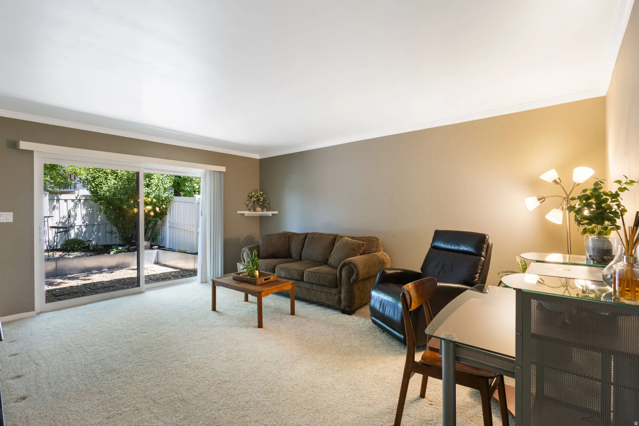 Living area featuring light-toned carpeting and neutral wall paint