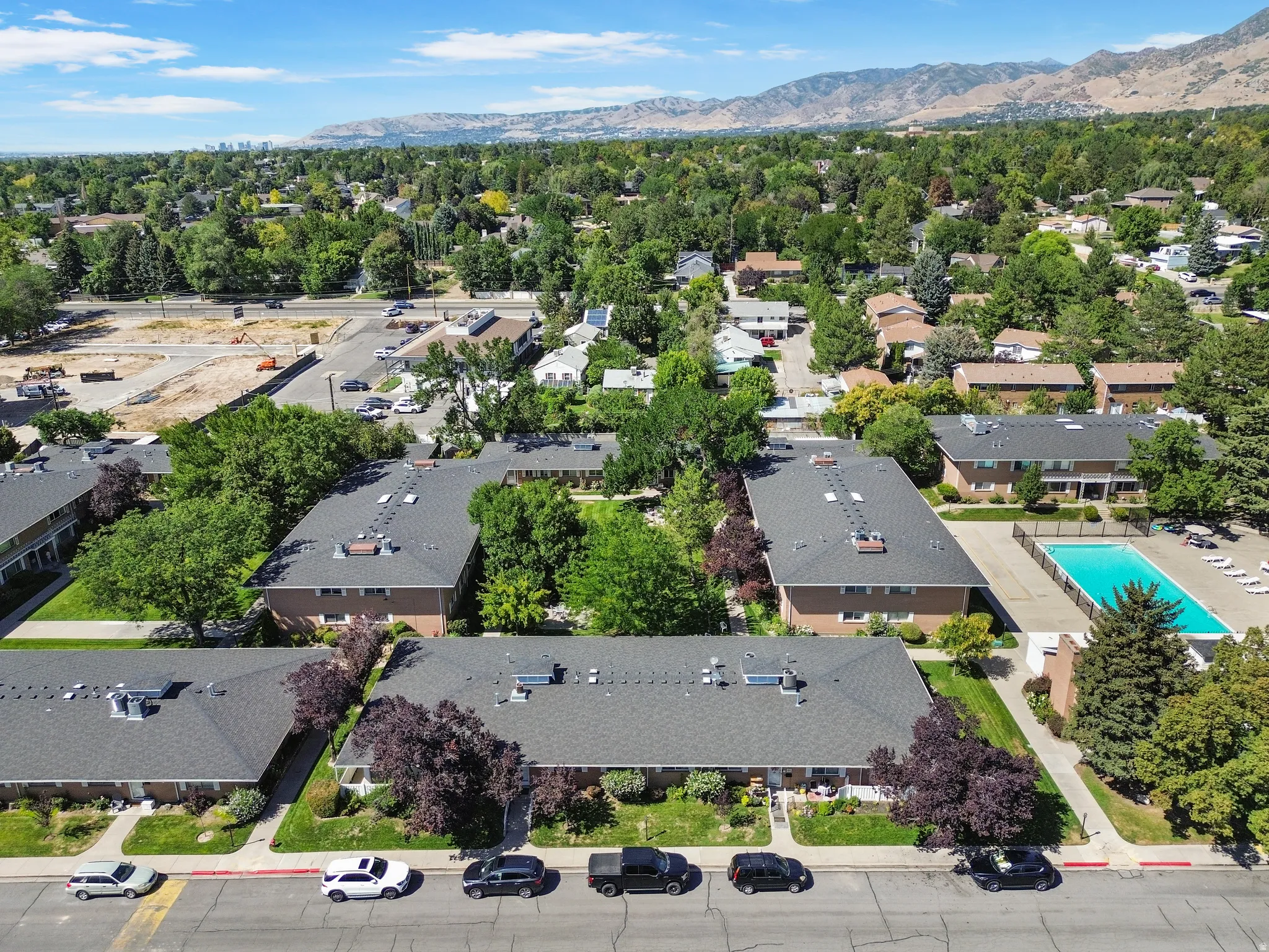 Aerial view showcasing multiple residential buildings with dark shingle roofs