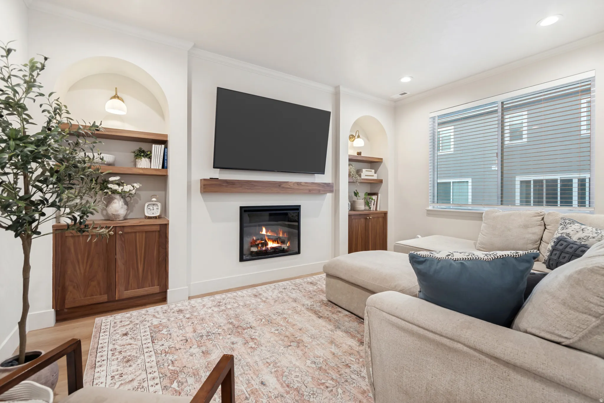 Living area featuring a built-in electric fireplace with a wood mantel