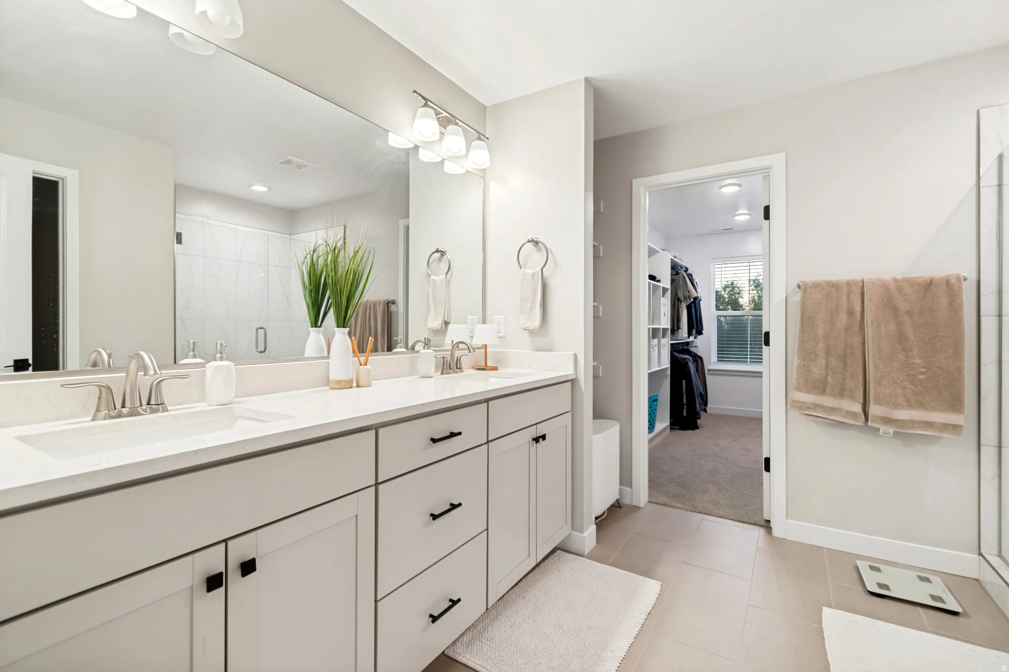 Double vanity with light countertops and undermount sinks