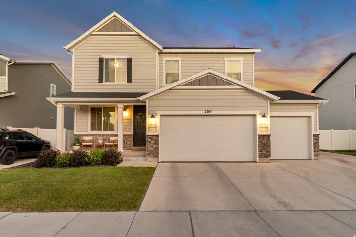 Two-story residence featuring light-colored siding and dark trim accents