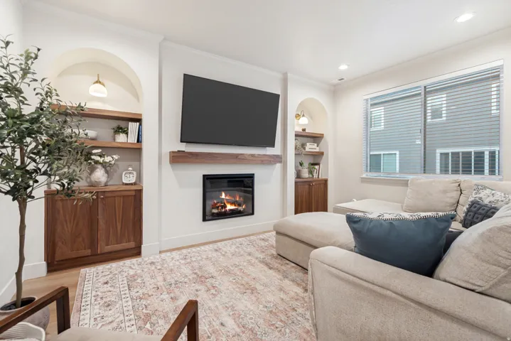 Living area featuring a built-in electric fireplace with a wood mantel